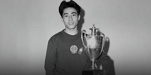 a old image black and white of asian man holding a trophy