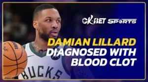 damian lillard man raising his hand wihile playing basketball